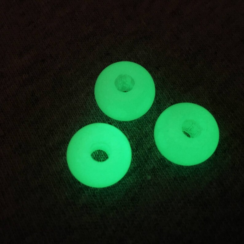 May include: Three glow-in-the-dark green plastic rings with a hole in the center.