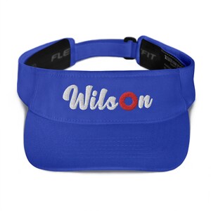 May include: Royal blue visor with a white embroidered "Wilson" with a red circle.
