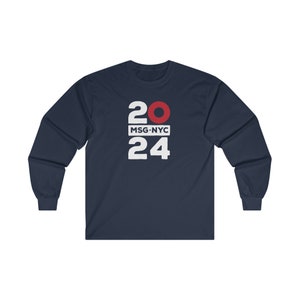 May include: Navy blue long-sleeve t-shirt with white text that reads "20 MSG-NYC 24" with a red circle in the middle of the "20".