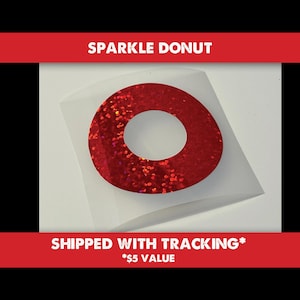 May include: Red glitter donut sticker with a white center hole. The sticker is on a white background.  "Sparkle Donut" is written in white text on a red background above the sticker. "Shipped with Tracking* $5 Value" is written in white text on a red background below the sticker.