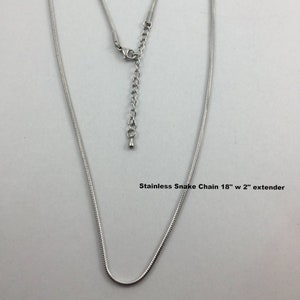 May include: Silver snake chain necklace with an 18 inch length and a 2 inch extender.  Stainless Snake Chain 18" w 2" extender.