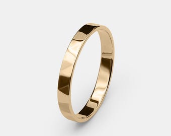 May include: A simple gold band ring with a smooth, polished finish.