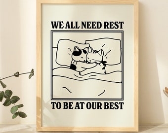 Puede incluir: Ilustración en blanco y negro de dos gatos acurrucados en la cama. El texto "WE ALL NEED REST TO BE AT OUR BEST" está impreso debajo de la imagen.