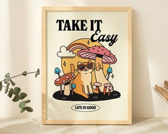 May include: A framed print with a yellow background and a cartoon cat wearing sunglasses sitting under a mushroom. The text "TAKE IT Easy" is in black letters above the cat and "LIFE IS GOOD" is below the cat.