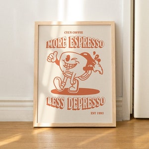 K&ouml;nnte beinhalten: Ein gerahmter Druck mit einer Cartoon-Illustration einer Kaffeetasse mit einem l&auml;chelnden Gesicht und dem Text "CYUN COFFEE MORE ESPRESSO LESS DEPRESSO EST 1993".