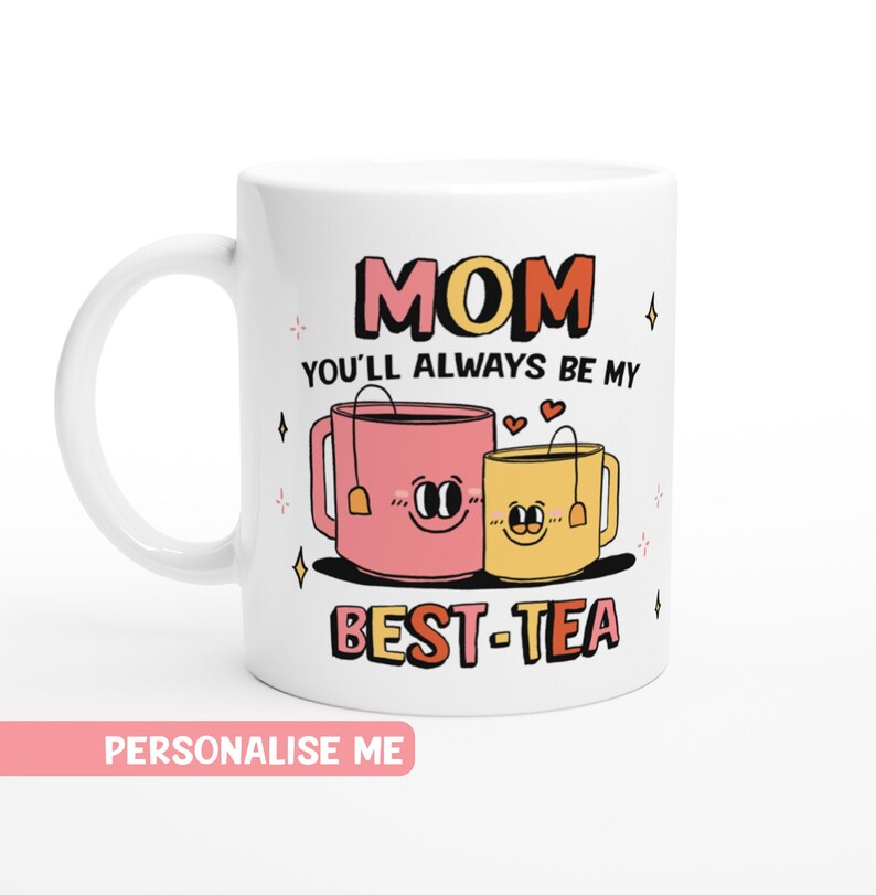 May include: White ceramic mug with a pink and yellow teacup design. The text "MOM YOU'LL ALWAYS BE MY BEST-TEA" is printed on the mug.