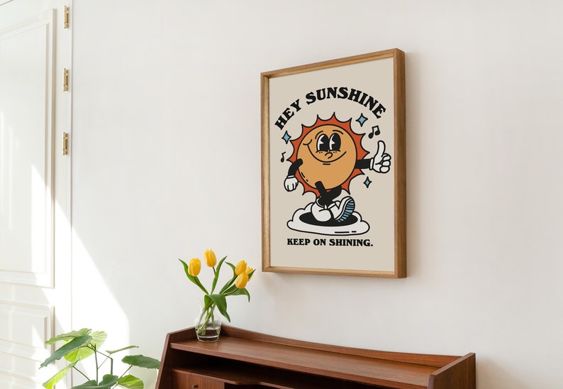 May include: A framed print with a cartoon sun character with the text "Hey Sunshine Keep on Shining."