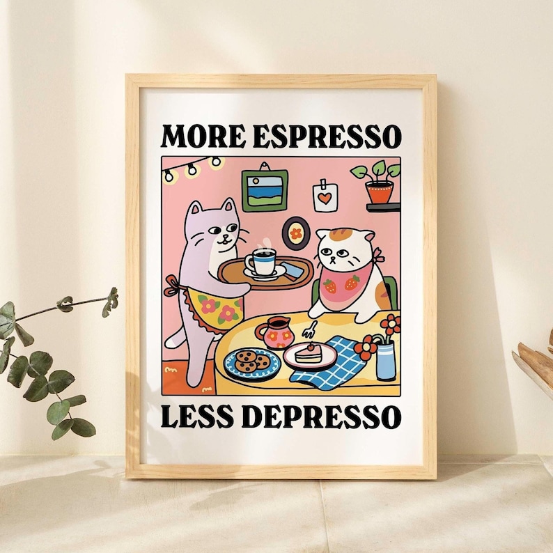 May include: A framed illustration with a pink background featuring two cats, one serving coffee to the other. The text reads "More Espresso Less Depresso".