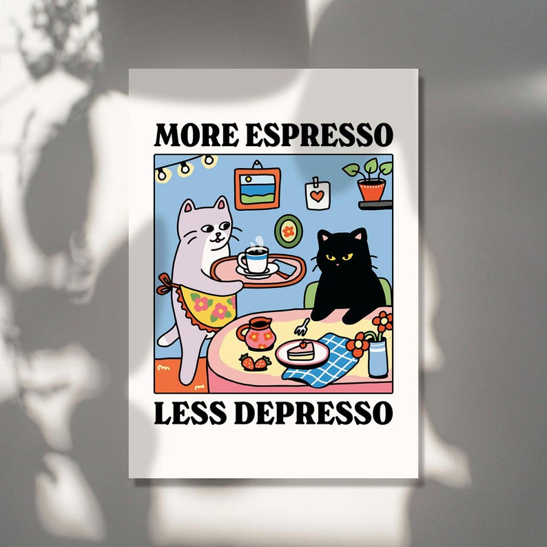 May include: A white and gray cat wearing a floral apron serves a cup of coffee to a black cat sitting at a table with a slice of cake. The text "MORE ESPRESSO LESS DEPRESSO" is written below the table.