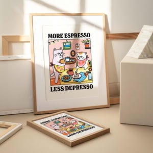 May include: A framed print with a cartoon illustration of two cats sitting at a table with coffee and cake. The text on the print reads "More Espresso Less Depresso".