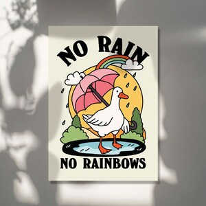 May include: A white duck with a pink umbrella standing in a puddle with a rainbow above it. The text "NO RAIN NO RAINBOWS" is below the duck.