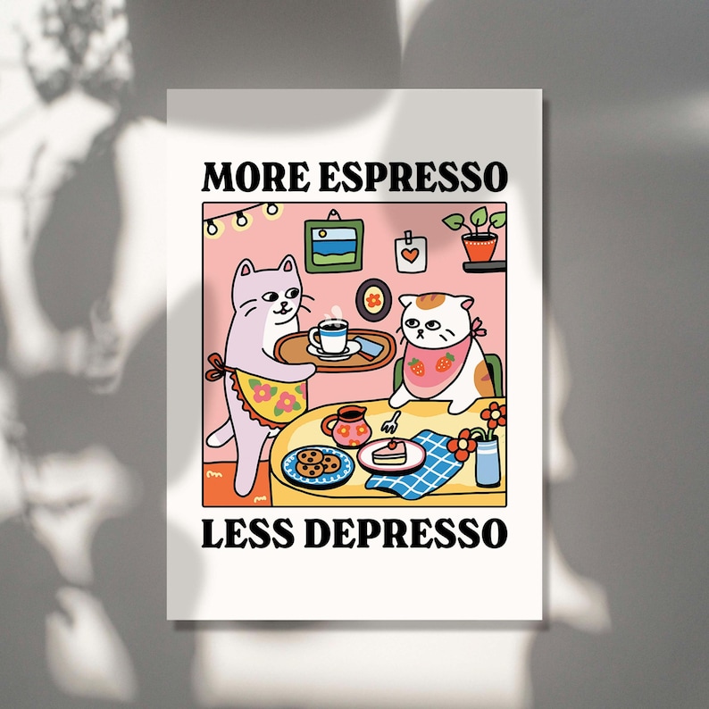May include: A pink and white illustration of two cats sitting at a table with a cup of coffee, a plate of cookies, and a slice of cake. The text "MORE ESPRESSO LESS DEPRESSO" is written in black letters at the top and bottom of the image.