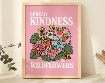 May include: A framed art print with a pink background and a floral design. The print features the words "SPREAD KINDNESS like WILDFLOWERS" in white. The illustration includes daisies, strawberries, and other colorful flowers.