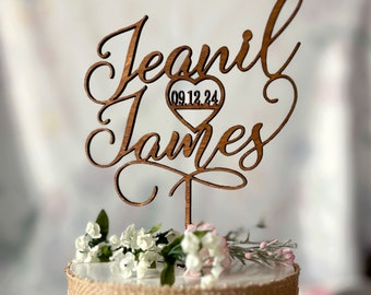 May include: Wooden cake topper with the names "Jeanil" and "James" in cursive script. A heart with the date "09.12.24" is in the center of the topper.