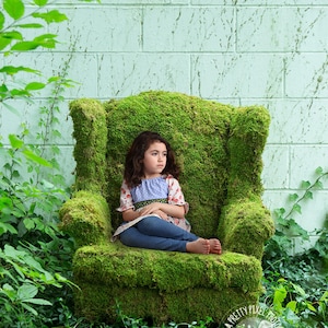 digital background for newborn composites of mossy chair in grass with a white wall. Moss covered chair for composites.