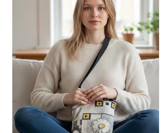 Fabric summer handbag lightweight roomy inside with two outside pockets and two inside pocket .Black strap and a zipper closure .