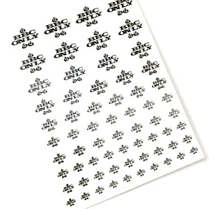 May include: A sheet of black and white stickers with the text "BBC ONLY" repeated multiple times. Each sticker features a small black teardrop shape.
