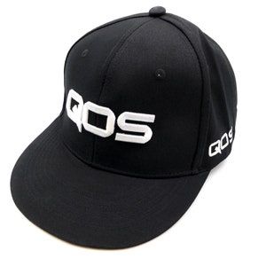 May include: Black baseball cap with a white embroidered logo that says "QOS". The logo is on the front of the cap and the word "QOS" is also embroidered on the side of the cap.