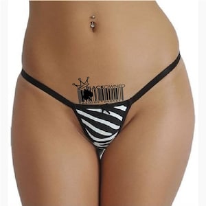 May include: Black and white zebra-striped underwear with a black waistband and a black barcode with the text "BLACKOWNED" and a crown above it.