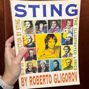 May include: A book titled "Sting: The Illustrated Lyrics" by Roberto Gligorov, featuring a collage of illustrations of Sting on the cover.