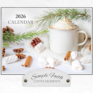 May include: A white mug filled with a coffee drink topped with whipped cream, set on a white knitted blanket. The image includes a 2026 calendar, pine sprigs, cinnamon sticks, star anise, and marshmallows. The text "Simple Faith Coffee Moments" is also visible.