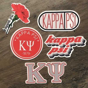 May include: A collection of stickers featuring the Greek letters and name "Kappa Psi". Designs include a red carnation, a pill-shaped sticker, a circular emblem with "1879", and a layered text design. The stickers are in red, white, and gray.
