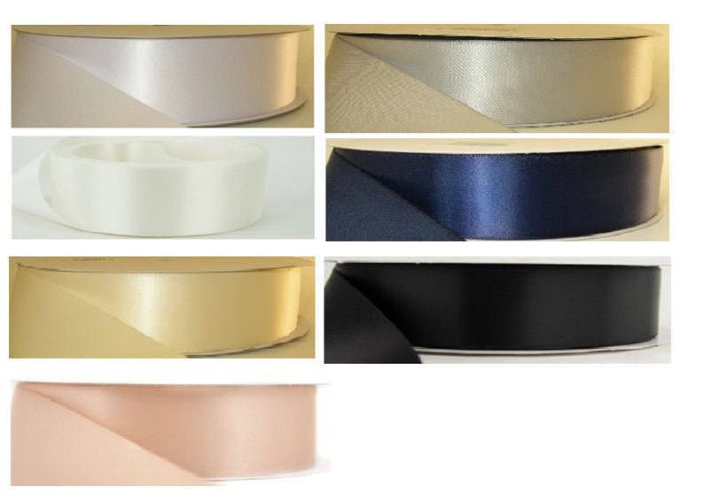 May include: Assortment of satin ribbon spools in various colors, including ivory, silver, navy blue, gold, and blush pink.