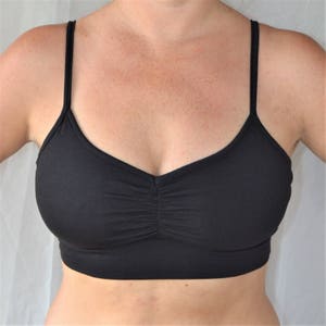 May include: A black sports bra with thin straps and a scoop neck.