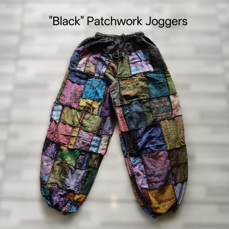 May include: Black patchwork joggers with a drawstring waist. The pants are made of various colorful fabric squares, including shades of blue, green, purple, and pink. The text "Black" Patchwork Joggers is at the top of the image.