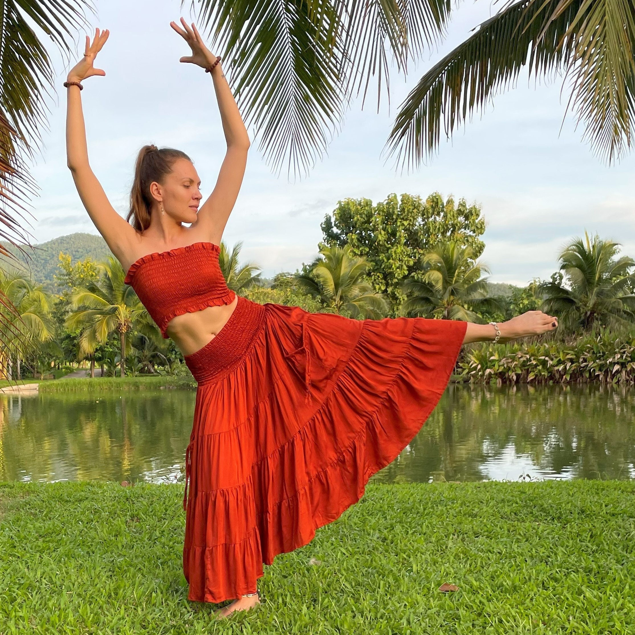Aphrodite Tiered Skirt with Pockets in Rust by Lotus Tribe - one size fits all.  Made of sustainable tree pulp Lyocell fabric. Vegan silk.