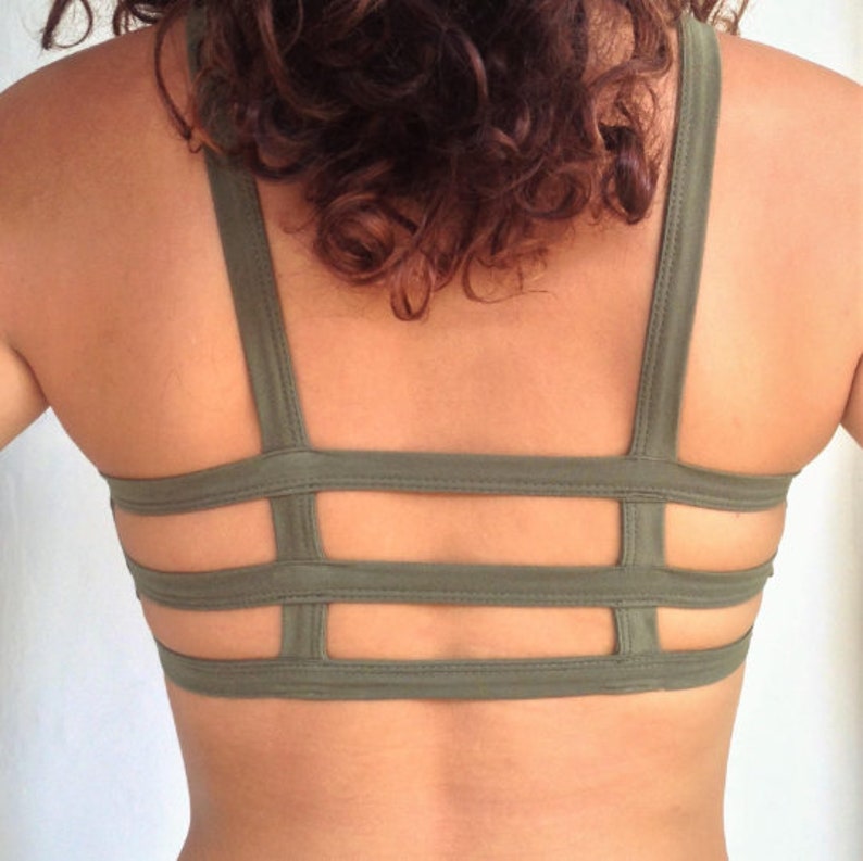 May include: A green sports bra with a criss-cross back design.
