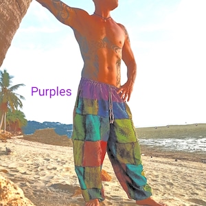 May include: Patchwork pants in shades of purple, green, red, and blue. The pants have a drawstring waist and a loose, comfortable fit. The word "Purples" is written in purple on the left side of the image. The pants are suitable for casual wear.