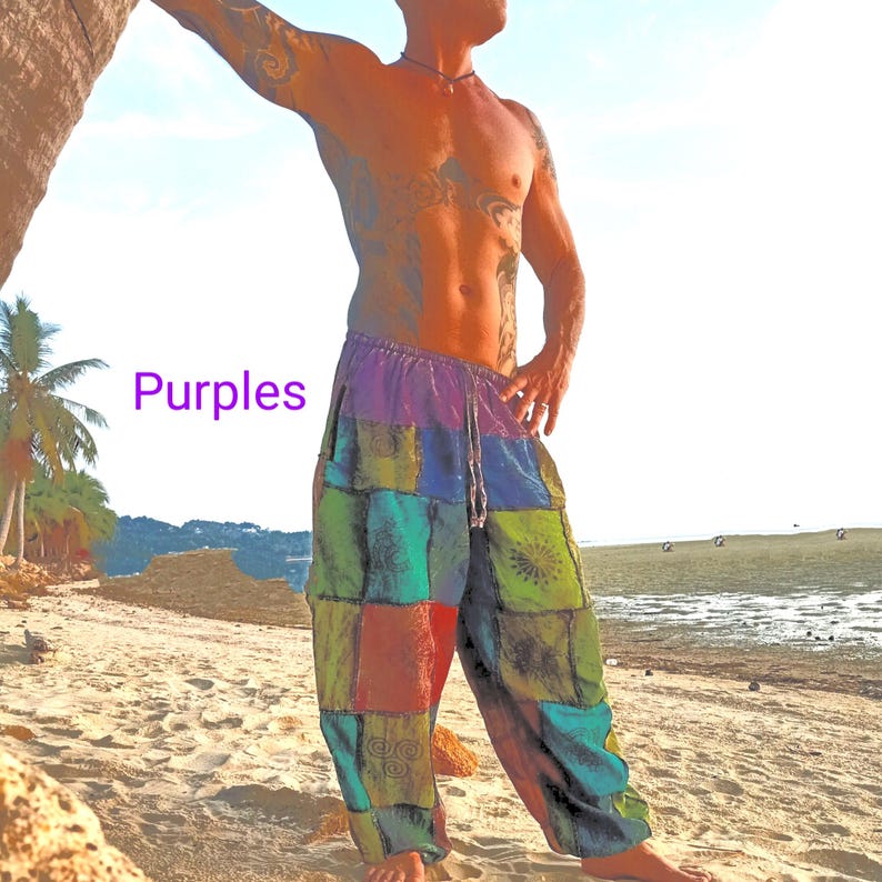 May include: Patchwork pants in shades of purple, green, red, and blue. The pants have a drawstring waist and a loose, comfortable fit. The word "Purples" is written in purple on the left side of the image. The pants are suitable for casual wear.