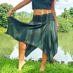 May include: A green and gold tie-dye skirt with a high waist and a flowing, asymmetrical hemline. The skirt is made of a soft, lightweight fabric and has a relaxed, bohemian style.
