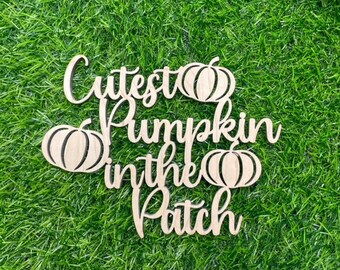 May include: Wooden sign with the text "Cutest Pumpkin in the Patch" and three carved pumpkin shapes.