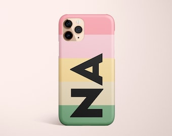 May include: A pink, yellow, and green phone case with the letters "AZ" in black block letters.