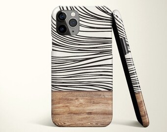 May include: A black and white abstract phone case with a wood grain design on the bottom half.
