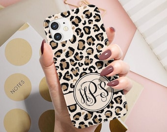 May include: A beige and brown leopard print phone case with a black circle monogram in the centre. The monogram is the letters "HPS" in a script font.