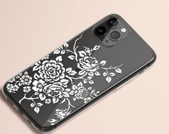 May include: A clear phone case with a white floral design. The case is designed for an iPhone with a triple camera lens.