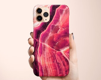 May include: A pink and red marble phone case with a geometric pattern. The case is designed for an iPhone.
