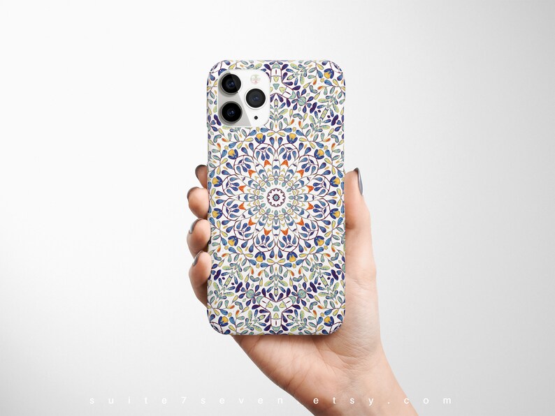 May include: A white iPhone case with a colorful mandala design. The design features blue, green, yellow, and orange colors.