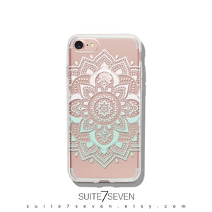 May include: A clear phone case with a white and light blue mandala design. The case is compatible with an iPhone 7. The text "SUITE7SEVEN" is printed on the bottom of the case.