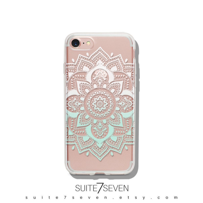May include: A clear phone case with a white and light blue mandala design. The case is compatible with an iPhone 7. The text "SUITE7SEVEN" is printed on the bottom of the case.