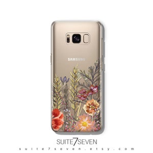 May include: A clear phone case with a floral design featuring red, orange, yellow, and purple flowers. The case is designed for a Samsung Galaxy phone and has the Samsung logo on the back.