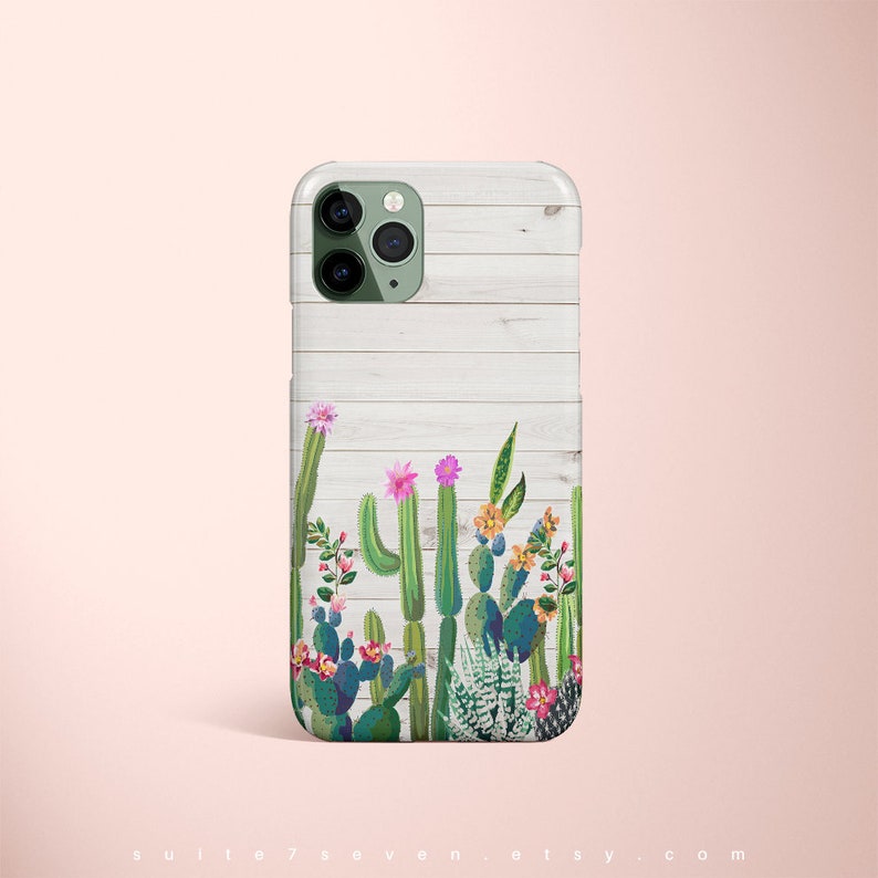 May include: A white woodgrain iPhone case with a green, pink, and yellow cactus and flower design.