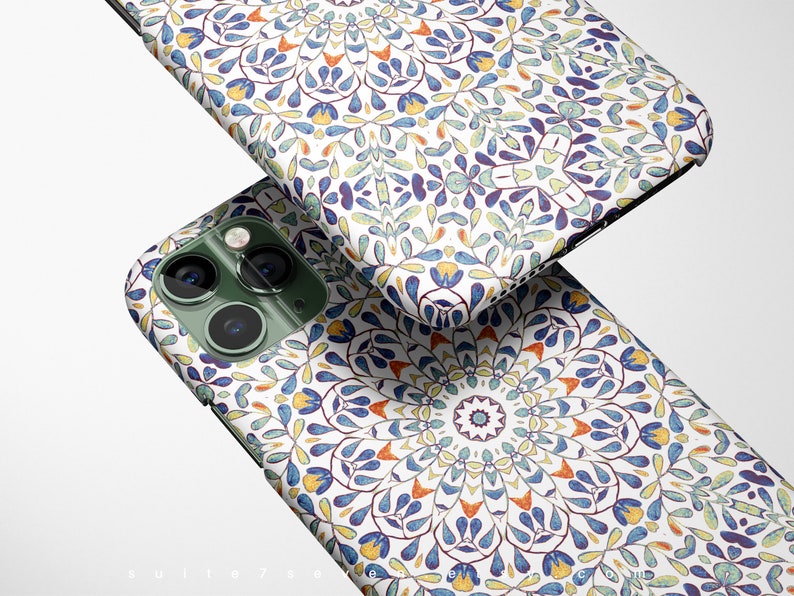 May include: A white phone case with a colorful mandala pattern. The case has a green camera bump with two lenses.
