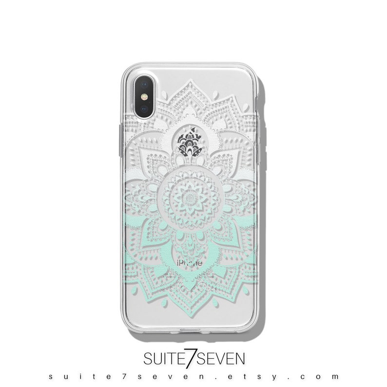 May include: A clear phone case with a white and light blue mandala design. The design is a gradient, with the white at the top and the light blue at the bottom. The case is for an iPhone.