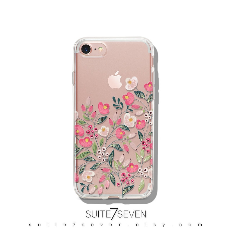 Puede incluir: Una funda transparente para tel&eacute;fono con un dise&ntilde;o floral con flores rosas y blancas y hojas verdes. La funda est&aacute; dise&ntilde;ada para un iPhone 7.