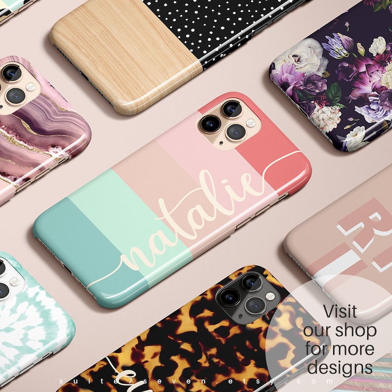 May include: A collection of colorful phone cases with various designs, including marble, floral, wood grain, and geometric patterns. The cases are all for the iPhone 11 Pro. The text "natalie" is written in white on a pink, green, and blue striped case.