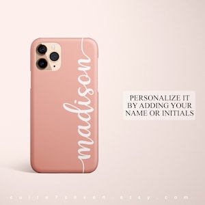 May include: A pink phone case with a white cursive name "madison" on the side. The text "PERSONALIZE IT BY ADDING YOUR NAME OR INITIALS" is visible below the phone case.